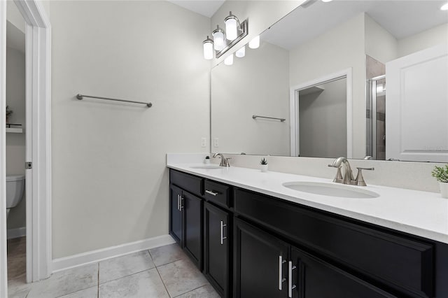 bathroom featuring vanity, toilet, a shower with door, and tile patterned flooring