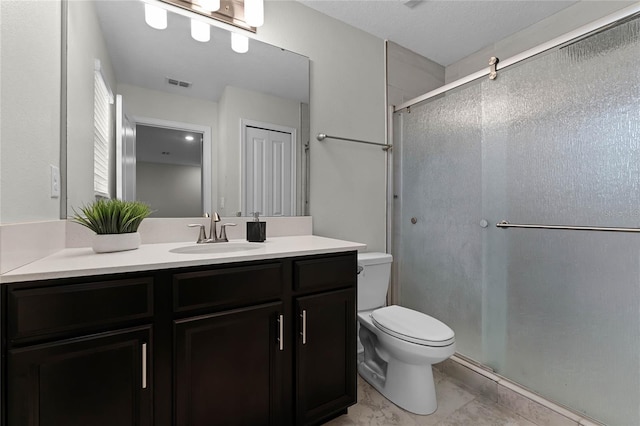 bathroom with vanity, toilet, and an enclosed shower