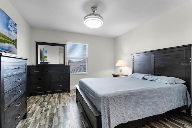 bedroom with wood-type flooring and a textured ceiling