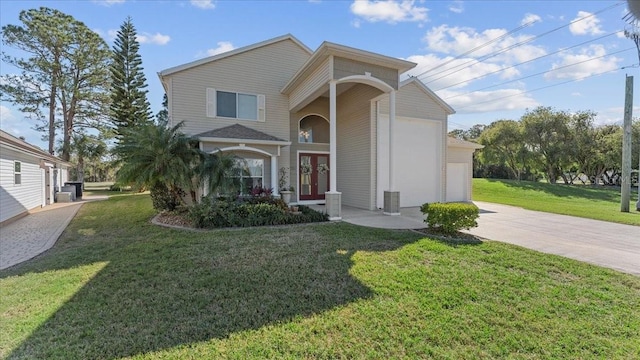 front of property featuring a front lawn and a garage