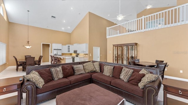 living room with high vaulted ceiling and ceiling fan