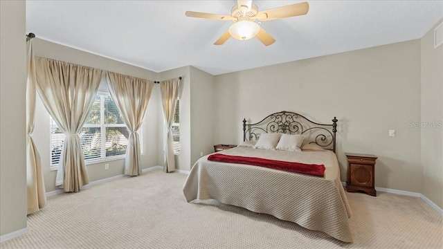 bedroom featuring ceiling fan and light carpet