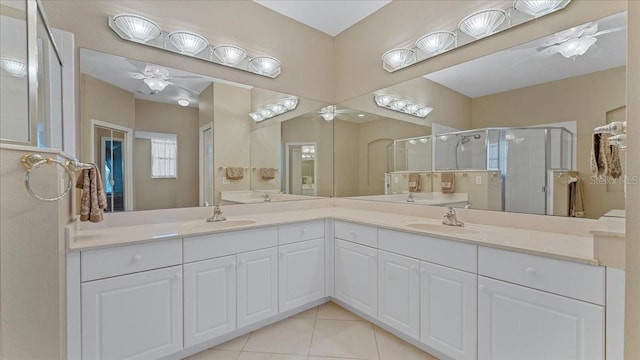 bathroom with ceiling fan, tile patterned flooring, walk in shower, and vanity