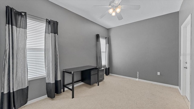 interior space with ceiling fan and light colored carpet