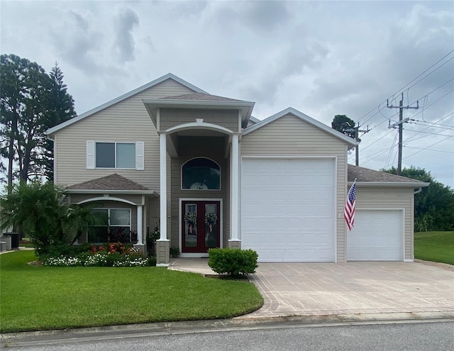 view of front property featuring a front lawn and a garage