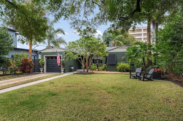 view of front of property with a garage and a front lawn