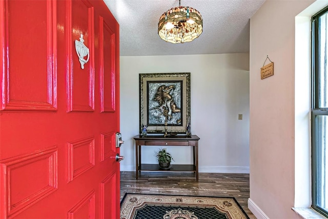 entryway featuring a textured ceiling and hardwood / wood-style floors