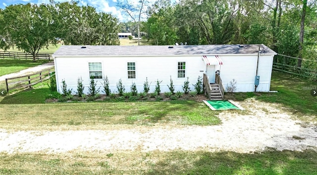 back of property featuring a lawn