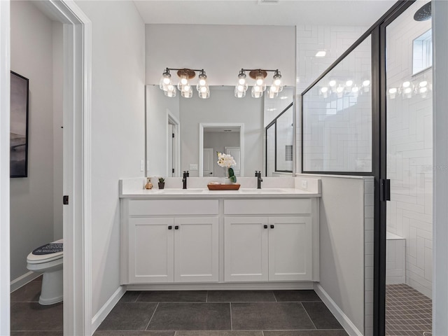 bathroom featuring a shower with shower door, tile patterned floors, toilet, and vanity