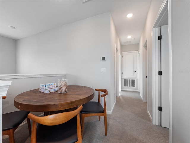 dining area featuring light colored carpet