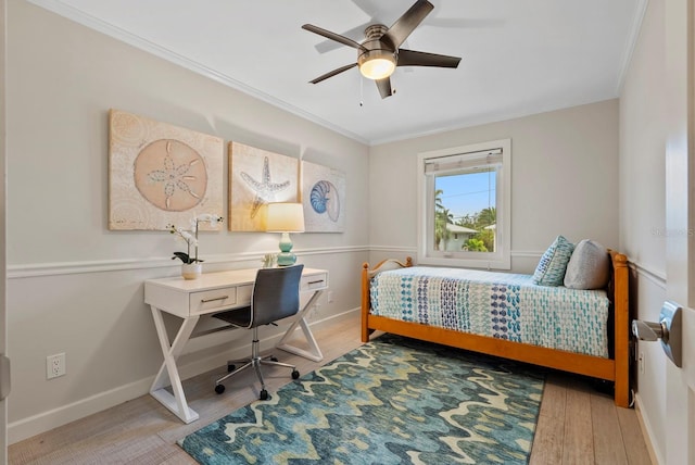 bedroom with hardwood / wood-style floors, ceiling fan, and ornamental molding