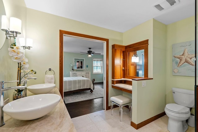 bathroom featuring toilet, tile patterned floors, and vanity