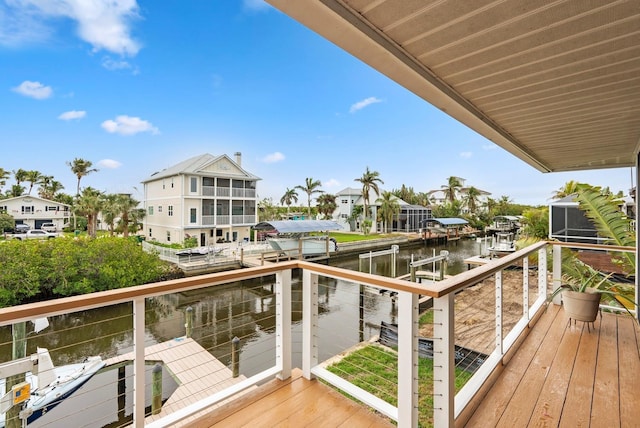 balcony featuring a dock and a water view