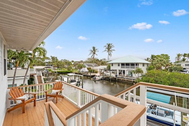 balcony featuring a boat dock and a water view