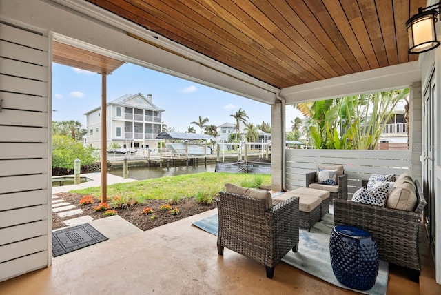 view of patio with outdoor lounge area and a water view