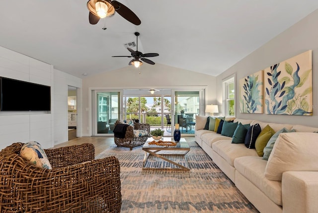 living room with hardwood / wood-style flooring, vaulted ceiling, and ceiling fan