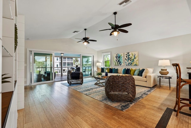 living room featuring vaulted ceiling and hardwood / wood-style floors