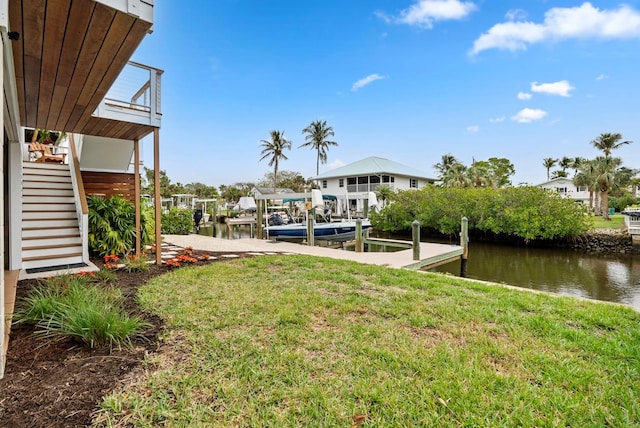 view of yard with a boat dock and a water view