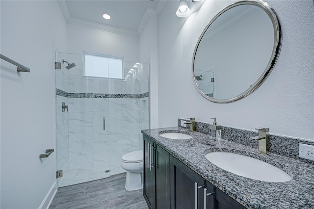 bathroom featuring toilet, vanity, an enclosed shower, and ornamental molding