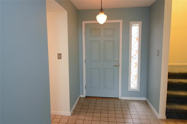 foyer entrance with plenty of natural light and light tile patterned floors