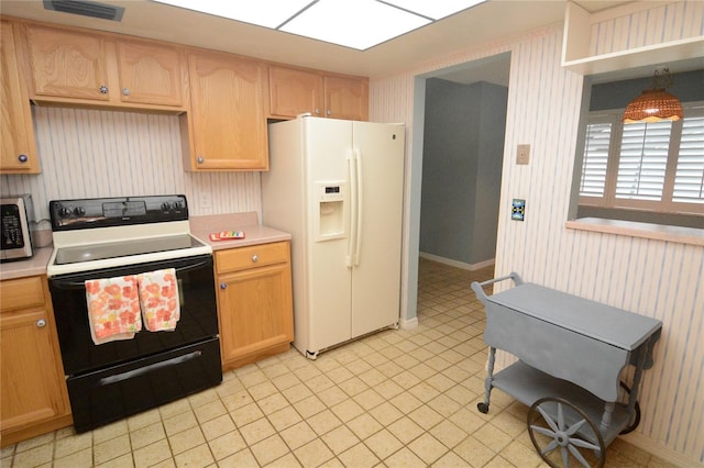 kitchen featuring white fridge with ice dispenser, light brown cabinets, and range with electric cooktop