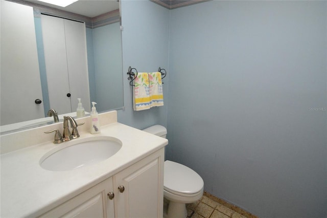 bathroom with vanity, toilet, and tile patterned flooring