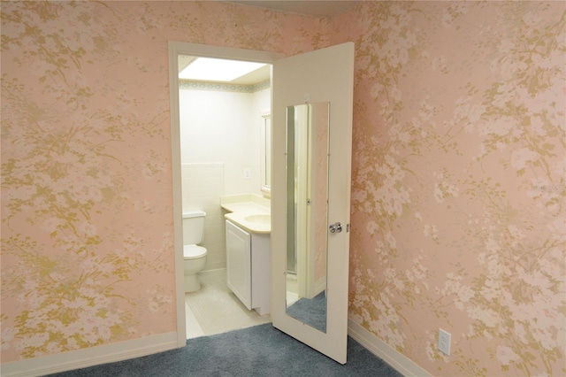 bathroom featuring toilet and vanity