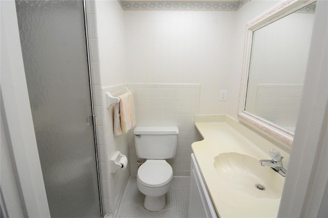 bathroom featuring an enclosed shower, tile patterned floors, vanity, tile walls, and toilet