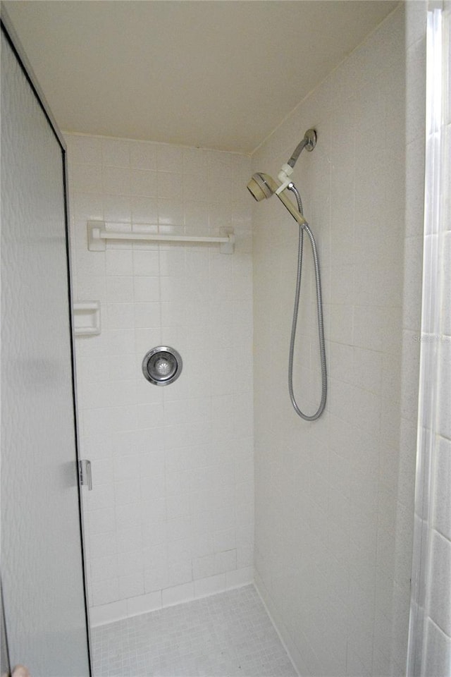 bathroom featuring tile patterned floors and tiled shower