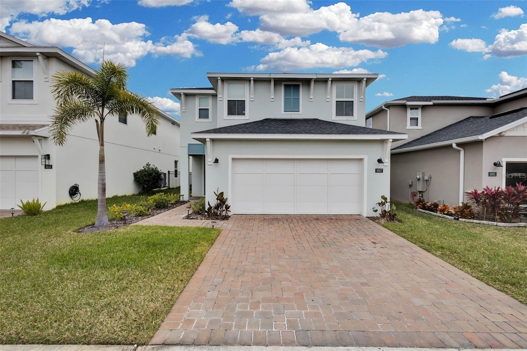 view of front of house with a front lawn and a garage