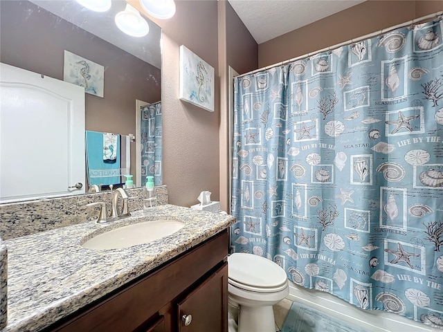 bathroom with a textured ceiling, toilet, and vanity