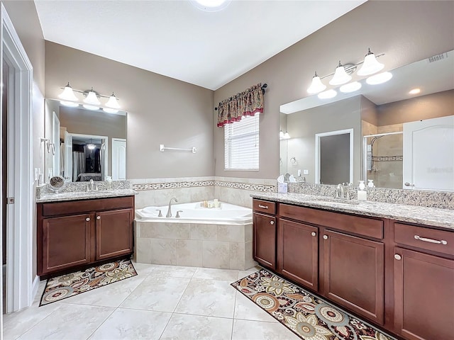 bathroom featuring vanity, tile patterned floors, and shower with separate bathtub