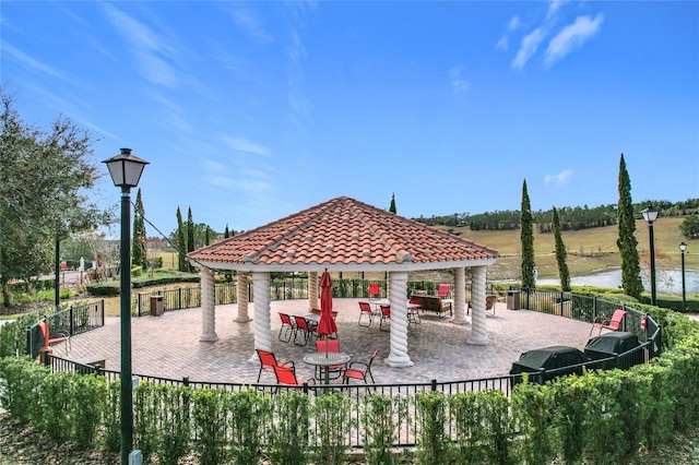 view of patio / terrace with area for grilling, a gazebo, and a water view