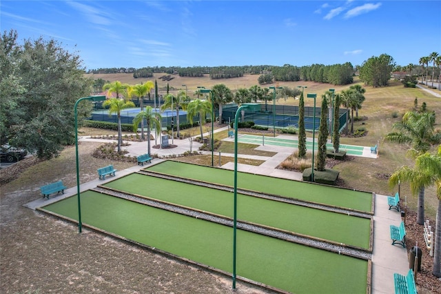 view of property's community with tennis court and a rural view