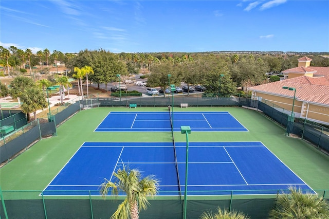 view of tennis court featuring basketball hoop