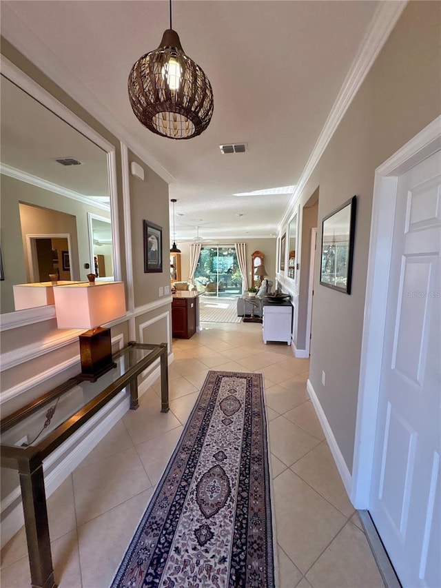 hall featuring crown molding and light tile patterned flooring