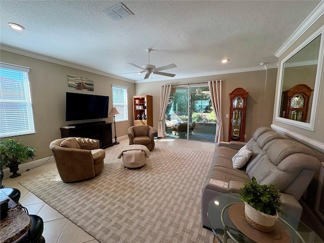 tiled living room featuring a textured ceiling, crown molding, and a healthy amount of sunlight