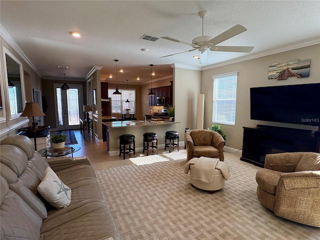 living room featuring plenty of natural light, a textured ceiling, and light tile patterned floors