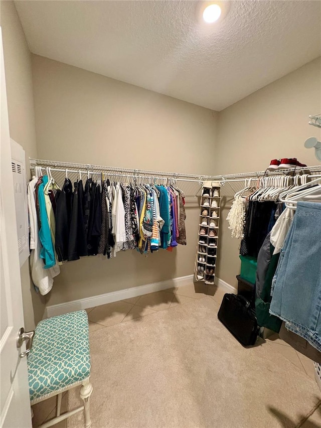 walk in closet featuring carpet