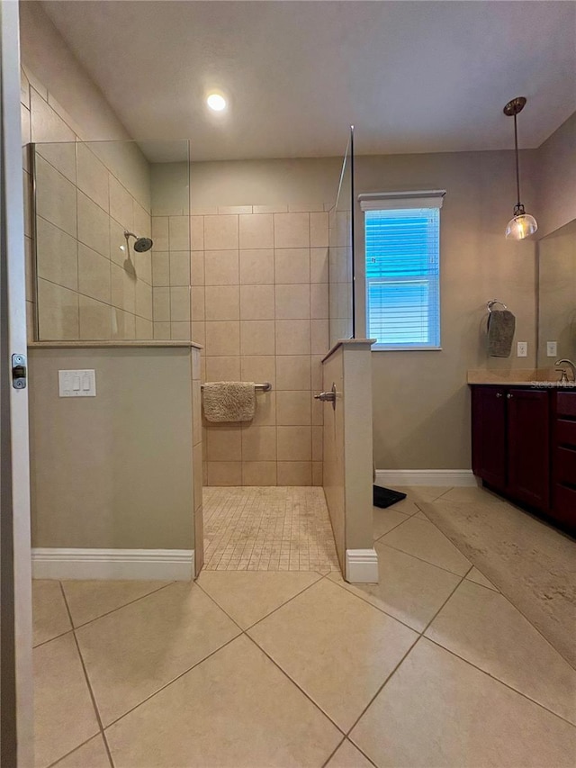 bathroom with vanity, tile patterned floors, and a tile shower