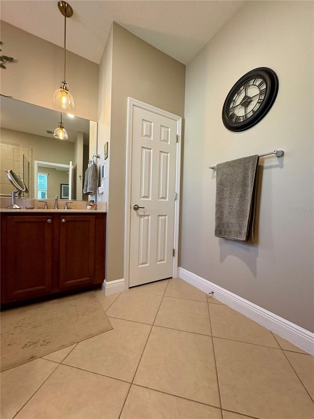 bathroom featuring lofted ceiling, vanity, and tile patterned flooring