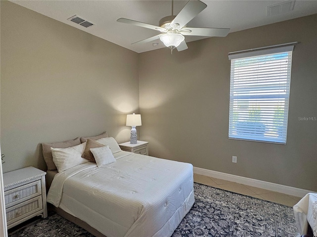 bedroom featuring ceiling fan and dark tile patterned floors