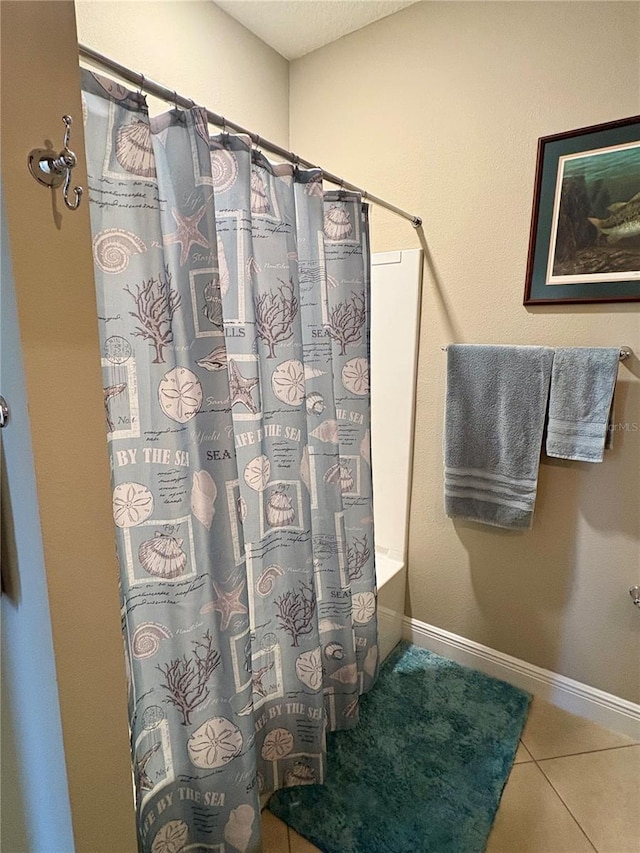 bathroom featuring shower / bathtub combination with curtain and tile patterned floors