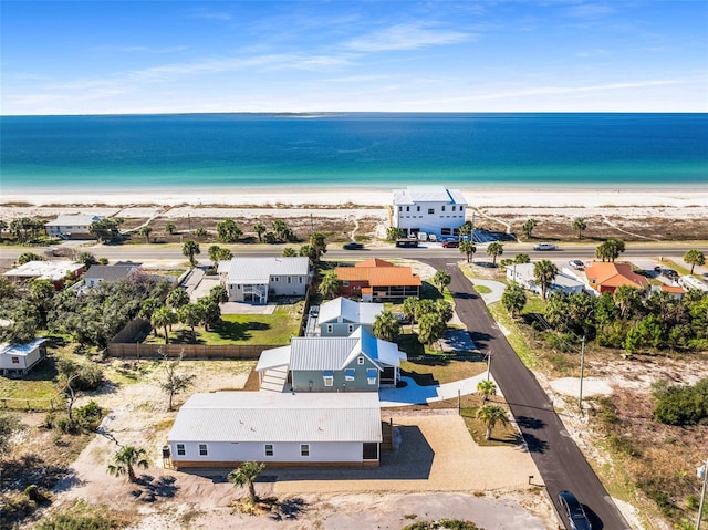 bird's eye view with a water view and a beach view