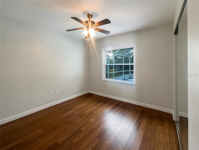 unfurnished room featuring ceiling fan and dark hardwood / wood-style flooring