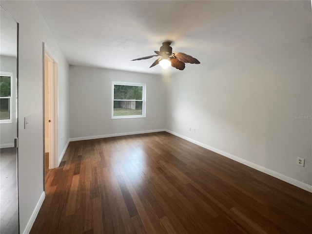 spare room with ceiling fan and dark wood-type flooring