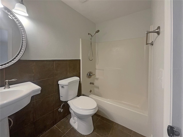 bathroom featuring toilet, shower / tub combination, tile walls, and tile patterned floors