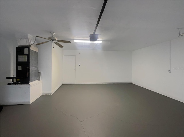 garage featuring heating unit and a garage door opener