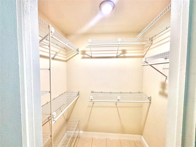 spacious closet with tile patterned floors