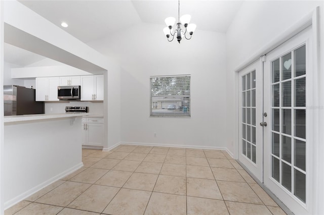 unfurnished dining area with vaulted ceiling, light tile patterned flooring, and an inviting chandelier